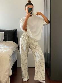 Livesso Conjunto de pijama con top de camiseta holgada de unicolor y pantalones estampados con dibujos florales de líneas en todo el diseño
