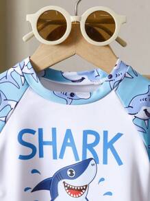 Toddler Boys' 1-3 Years Old Fashion Swimwear Set. Shark Print Sports Outfit. White Top With Light Blue Sleeves And Blue Shark Printed Shorts Set, Bright Colors, Suitable For Baby Boy's First Beach Trip And Swimming, Stretchy Fabric For Easy Movement, Perfect For Toddlers, Fashionable And Adorable Beach Look Boy Clothes For Kids Baby Boys Sets Baby Boy Beach Wear Toddler Beach Wear Boy Clothes For Baby Baby Boys Clothing Summer