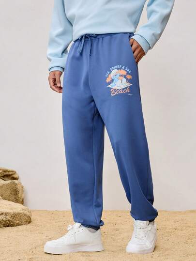 SHEIN X The Smurfs Pantalones de chándal casuales para hombre con estampado de dibujos animados y cintura con cordón