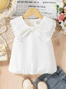 The New Style Of Short-Sleeved Chiffon Top With A Bowknot For Young Girls. It Features A Bubble Hem, Is Comfortable, And Represents The Fashion , Being Elegant, Sweet, And Cute, A Must-Have For Daily Wear