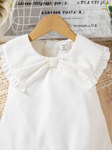 The New Style Of Short-Sleeved Chiffon Top With A Bowknot For Young Girls. It Features A Bubble Hem, Is Comfortable, And Represents The Fashion , Being Elegant, Sweet, And Cute, A Must-Have For Daily Wear