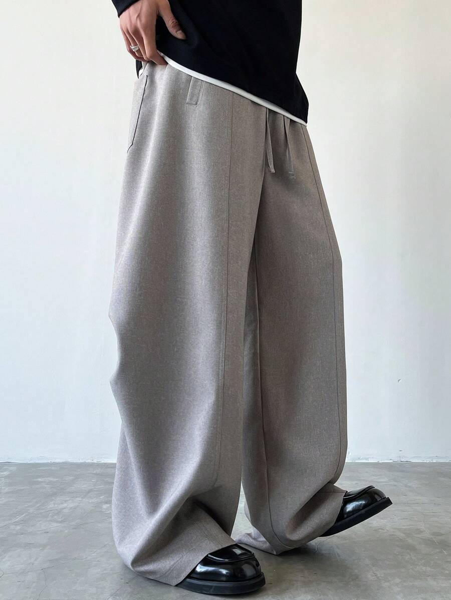 Claim Dot 男士休闲装，这款宽松的摩卡棕色长裤采用类似亚麻质感的印花面料，后腰处饰有创意褶裥设计。这款长裤清爽透气，是春夏的理想之选，也非常适合情侣搭配，是送给男友或老公的绝佳礼物。