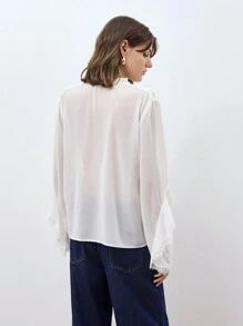 Maija Blusa de manga abullonada con cuello en V y ribete de volantes, camisa holgada y versátil de manga larga con botones delanteros y detalles de volantes en estilo bohemio para principios de primavera, en un look urbano y elegante