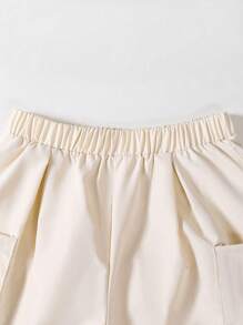 SHEIN 2 pièces ensemble casual énergique pour garçon préadolescent. Le Top est un t-shirt à manches courtes avec des couleurs contrastées marron et blanc, vibrant et énergique. Associé à un short blanc avec des poches latérales pratiques pour que les enfants puissent ranger de petits objets. La conception globale est simple et moderne, convenant aussi bien pour le port quotidien casual que pour les sports, permettant aux enfants de profiter des sports tout en mettant en valeur leur charme unique.