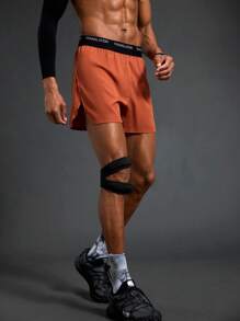 Manfinity Sport Polished Shorts esportivos com fenda lateral e cós em bloco de cores masculino