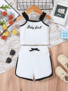 Baby Girl Casual Sports-Inspired Fashion Outfit, Black & White Color Block Design. Ruffled Shoulder Strap Top With "Baby Girl" Print, Paired With Loose White Shorts With Black Contrast Trim. Accented With Black Bowknot At Waist, Suitable For Everyday Wear, Family Gatherings And Relaxed Outdoor Activities.