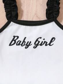 Baby Girl Casual Sports-Inspired Fashion Outfit, Black & White Color Block Design. Ruffled Shoulder Strap Top With "Baby Girl" Print, Paired With Loose White Shorts With Black Contrast Trim. Accented With Black Bowknot At Waist, Suitable For Everyday Wear, Family Gatherings And Relaxed Outdoor Activities.
