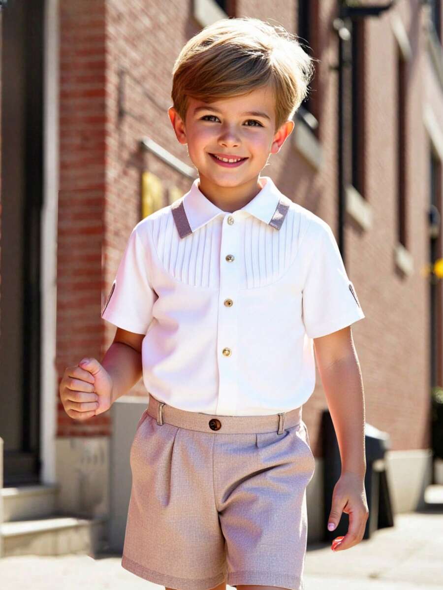 SHEIN 2 Pieces Set Young Boys Casual Sport Academy With Collar Front Pleated Sleeves With Cuff Buttons Short-Sleeved Shirt And Suit Shorts Gentleman's Outfit Kids Outfits Young Boy Clothes Back To School Boys Set Suitable For Birthday Party, Party, Performance, Wedding, Baptism, Opening Ceremony Suitable For Daily Suitable For School Suitable For Travel Suitable For Spring And Summer Season