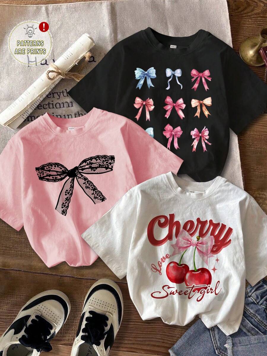 SHEIN Süße Schleife, Kirsch-Muster Lässig Cartoon Grafik T-Shirts in Weiß, Schwarz, Rosa für Kleine Mädchen, Kurzarm, geeignet für den Sommer - Verschiedenfarbig - Übersicht 1