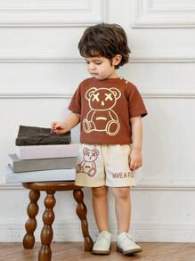 Ensemble de 2 pièces pour bébé garçon, T-shirt à imprimé ours mignon et short blocs de couleurs en tissu nid d'abeille, style casual, matériau doux et confortable, convient pour les vacances, les voyages, l'école, les rassemblements quotidiens, les sports, le printemps/été