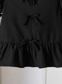 Blusa para niña con cuello en V, mangas abullonadas, volantes en el bajo y decoración de moño