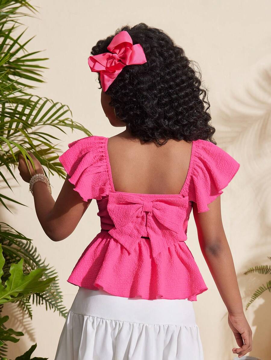 SHEIN Blusa rosada con manga corta, textura de tela, diseño de lazo en la espalda y dobladillo con volantes para niña preadolescente - Rosa - Ver 1