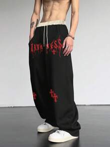 Manfinity EMRG 男士宽松十字架和字母图案抽绳腰部运动裤街头潮流服饰，适合狂欢