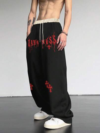 Manfinity EMRG 男士宽松十字架和字母图案抽绳腰部运动裤街头潮流服饰，适合狂欢