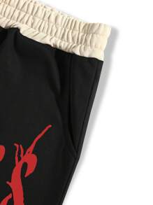 Manfinity EMRG 男士宽松十字架和字母图案抽绳腰部运动裤街头潮流服饰，适合狂欢