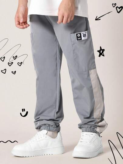 SUMWON 弹性裤脚运动裤，运动性能尼龙慢跑裤，带实用口袋，侧面板细节，街头风格，青少年训练裤