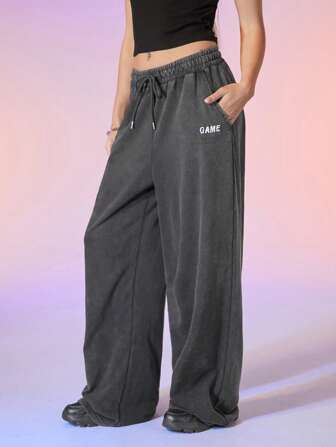 Manfinity UZERO Pantalon unisexe casual en tricot chiné avec cordon de serrage à la taille et jambes larges, motif brodé de lettres. Convient pour un port quotidien
