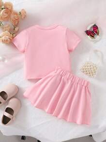 طقم تيشرت بأكمام قصيرة ذو رقبة دائرية + تنورة بخصر مطاطي ، لفتاة طفلة، مزين بالشريط والعقدة، لون سادة ، مريح، ناعم، أنيق وجميل، مناسب للربيع والصيف، 2 قطعة - وردي - مشاهدة 8