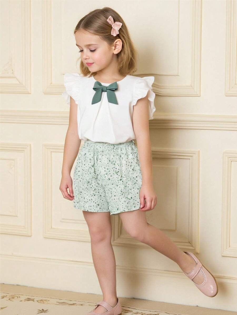 Souflis Souflis Bộ áo hai dây nơ màu tương phản theo phong cách đồng quê kiểu Pháp cho bé gái + quần short họa tiết hoa, dễ thương & giản dị, tươi mát mùa xuân/hè - trắng - Xem 1