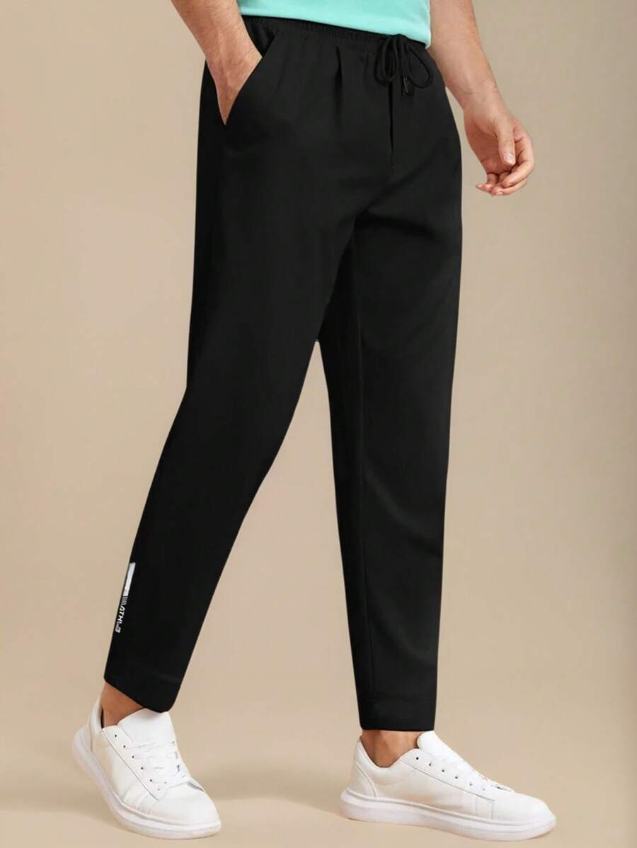 Manfinity Homme Pantalones casuales de unicolor para hombres con bolsillos y cordón en la cintura - Joggers negros para hombres - Ropa de hombre - Pantalones de hombre