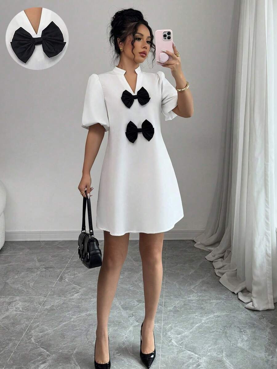 Elenzga Vestido mini de unicolor con cuello en V, mangas abullonadas y decoración de lazo, para mujer, nuevo para primavera/verano, de estilo casual y elegante - Blanco - Ver 1