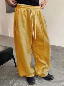 Manfinity Homme Pantalones deportivos casuales para hombre de unicolor con cordón en la cintura y bolsillos, pantalones deportivos versátiles con pernera ancha y holgada