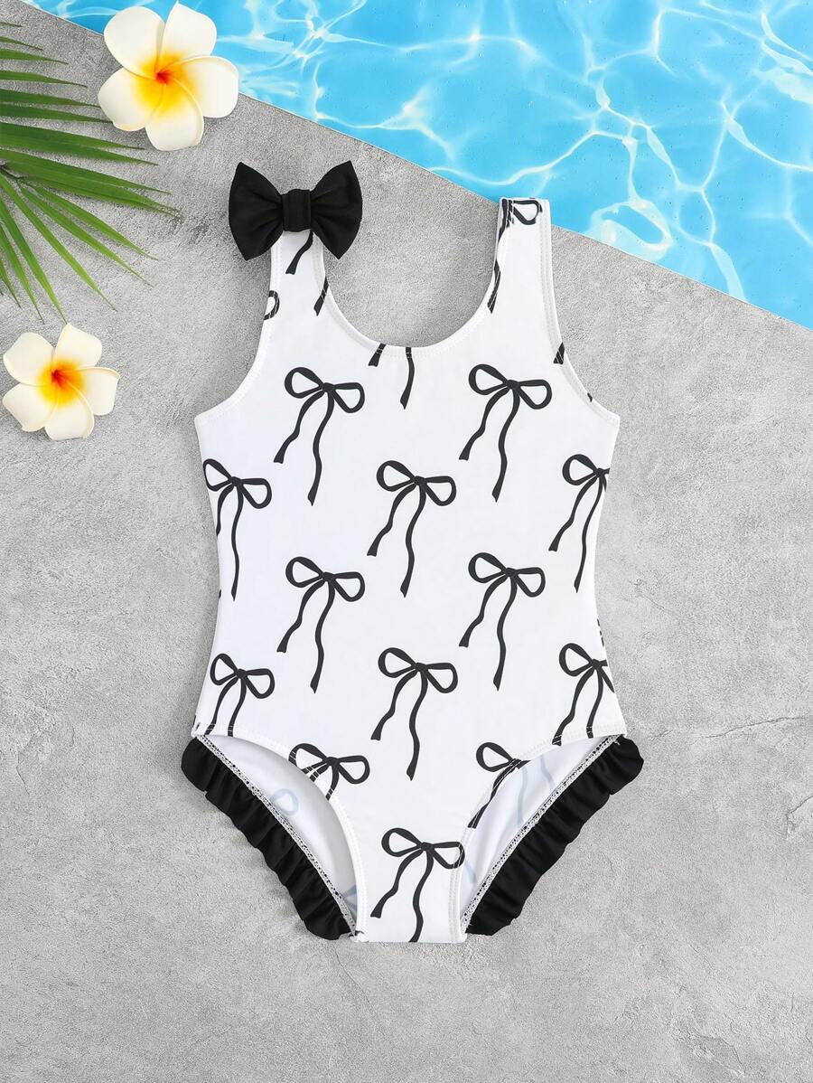 Young Girls One-Pieces - Adorable Black Bow One-Piece Swimsuit. Features Soft Knitted Fabric, Contrast Color Ruffle Trim On Shoulders, And A Classic Bow Accent. Fashionable, Casual, Yet Chic Design. Perfect For Swimming, Summer Vacations, Beach Trips, Pool Parties, And Holiday Getaways. - Black and White - View 1