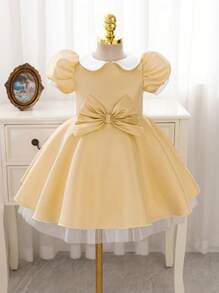 فستان أميرة ذو أكمام متنفخة فاخر وذهبي اللون مزين بشريط للخصر مناسب للحفلات الرسمية والأعياد