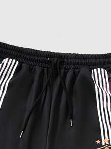 ROMWE MEN Anime Pantalones de chándal holgados con cordón de cintura y estampado de letras y leopardo para hombre