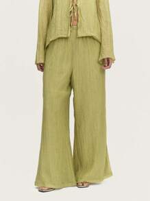 Nöista Pantalones plisados de un elegante silueta en tono verde pastel fluido. Ideales para el verano europeo, reuniones de Pascua o ropa de playa.