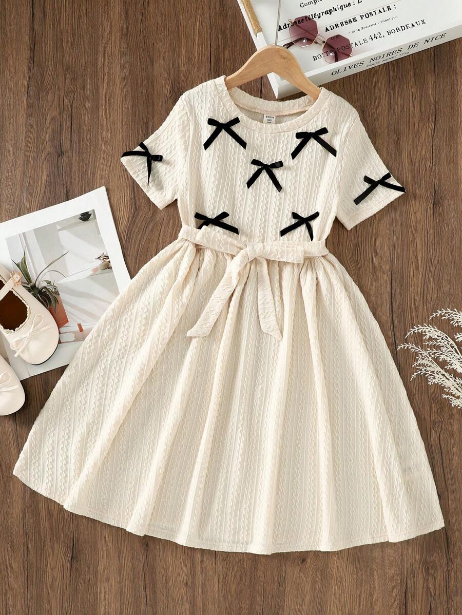 SHEIN Tween Girl Solid Color Knitted Round Neck Bow Decor Textured Waist Fitted Short Sleeve Elegant Dress, Casual Wear, Back To School, Lady Style - Beige - View 1