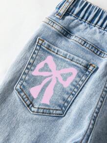 年轻女孩休闲时尚牛仔裤，甜美蝴蝶结后袋涂鸦印花，简单百搭浅蓝色水洗喇叭牛仔裤