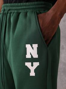 SUMWON Pantalón de chándal esencial de entrepierna caída, de ajuste recto, de rendimiento atlético, de uso diario, con cordón y logo de NY para otoño e invierno