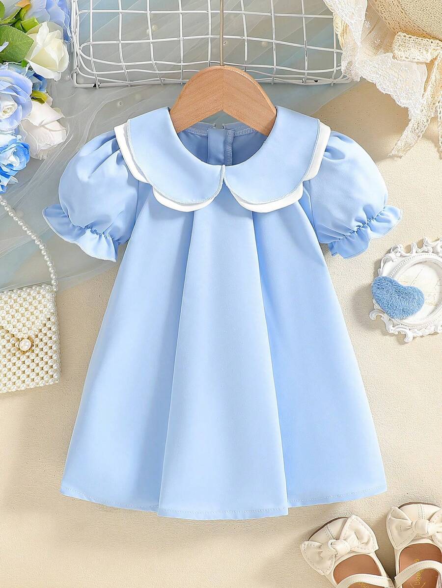 SHEIN 女婴泡泡袖双层彼得潘领 A 字裙。优质面料，A 字廓形。泡泡袖和双彼得潘领设计增添一丝俏皮和可爱。无论是日常穿着还是特殊场合，这款连衣裙都会让您的宝宝成为众人瞩目的焦点，是宝宝衣柜中必备的时尚单品。 - 藍色 - 查看 1