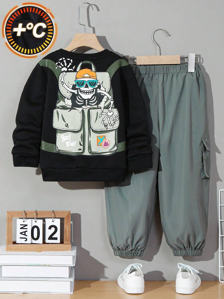 SHEIN Toddler Boys' Leisure Loose-fit Hat-wearing Skull Printed Sweater With Shoulder Bag And Side Pockets, Along With Tapered Pants With Prints