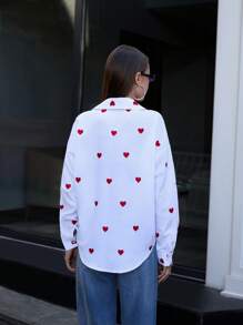 RueChic Blusa donna con bottoni, maniche lunghe, con ricamo a cuore intrecciato, di colore unito, per uscite