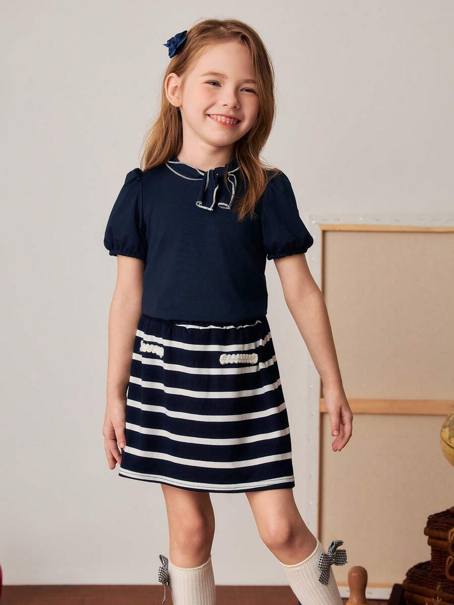 PrepCrw Set aus marineblauem T-Shirt mit Schleifen-Dekor und gestreiftem A-Linien-Rock im Collegestil für Kleine Mädchen, Frühling/Sommer - Verschiedenfarbig - Übersicht 1