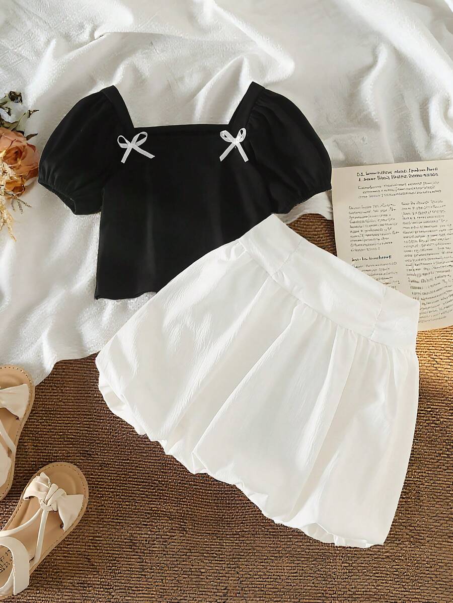 مجموعة تي شيرت بياقة مربعة وأكمام منفوشة وكم قصير بلون متماسك مع فيونكة زخرفية، وتنورة قصيرة خصر عالي بلون متماسك للفتيات موضة الكاجوال - أبيض وأسود - مشاهدة 1