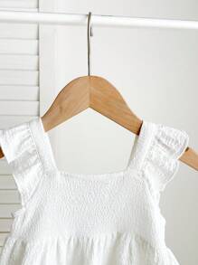 Blusa blanca casual y texturizada con lazo para bebés niñas, versátil para el verano