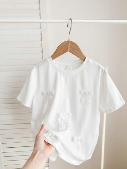SHEIN Tween Girls 可爱 3D 蝴蝶结设计白色 T 恤，百搭休闲日常穿着，适合任何场合