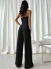 Firerie 推出新款优雅、浪漫、时尚女装，女士黑色连体裤，端庄大方，V 领设计，下摆开衩褶皱设计。非常适合音乐会和音乐庆典、生日派对、日常时尚穿着、度假穿着、都市时尚、时装秀、返校时尚，也适合浪漫约会、婚礼和春夏童话核心活动。 - 黑色 - 查看 2