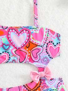 Traje de baño de una pieza con estampado de corazones y lazo para niña joven (diseño de estampado aleatorio)