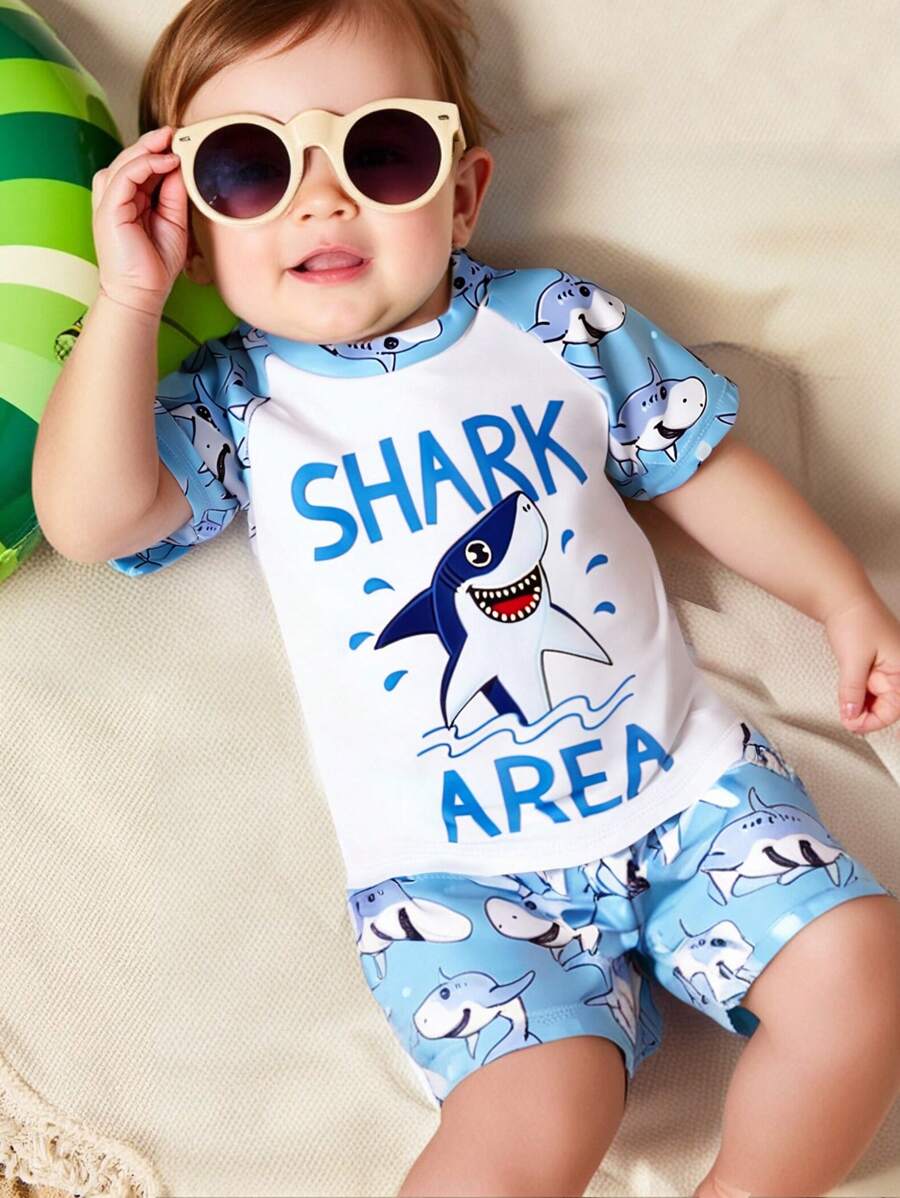 Toddler Boys' 1-3 Years Old Fashion Swimwear Set. Shark Print Sports Outfit. White Top With Light Blue Sleeves And Blue Shark Printed Shorts Set, Bright Colors, Suitable For Baby Boy's First Beach Trip And Swimming, Stretchy Fabric For Easy Movement, Perfect For Toddlers, Fashionable And Adorable Beach Look Boy Clothes For Kids Baby Boys Sets Baby Boy Beach Wear Toddler Beach Wear Boy Clothes For Baby Baby Boys Clothing Summer