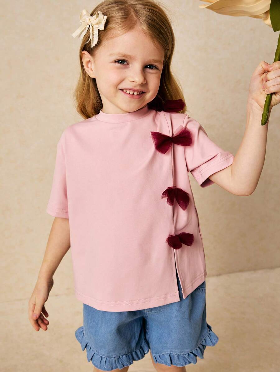 SHEIN Camiseta de cuello redondo para niñas jóvenes y elegante con decoración de lazo rosa, primavera/verano - Rosa - Ver 1