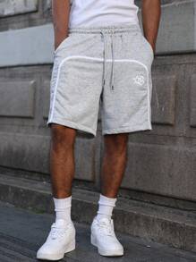 Manfinity Streetrush Pantalones cortos con cordón en la cintura y estampado de estrella de cinco puntas con cinta a rayas para hombres
