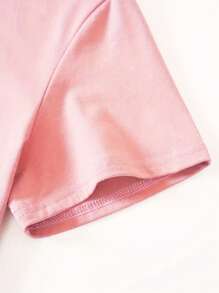 T-shirt à col rond pour femmes avec imprimé de nœud pailleté