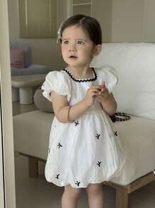 فستان فتيات صغيرات مطبوع برسوم الفراشات بأكمام منتفخة مطبوع بالكامل، مناسب للبنات الصغار للارتداء في جميع المناسبات الصيفية ، نسيج أبيض مع نمط أسود وحاشية دانتيل تجعل الطفلة تبدو أكثر فخامة وجذابة وعذبة - لون مشمشي - مشاهدة 7