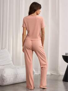 Conjunto de pijama casual de punto acanalado para mujer con cuello redondo y manga corta, y pantalones