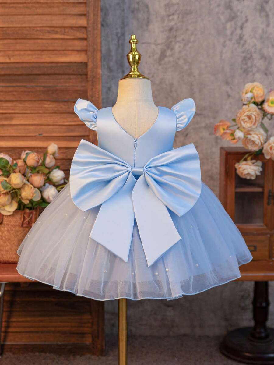 SHEIN Glamorique Kids 婚礼宾客花童花童舞会礼服，女婴公主裙，蓝色缎面小飞袖更添俏皮可爱。裙摆采用白色珍珠网眼设计，背面幸运V型可拆卸缎面大蝴蝶结，适合生日、舞会、婚礼、节日、正式场合、舞台钢琴表演、主持人、派对或特殊场合。日常穿着 - 藍色 - 查看 1