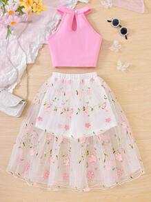 Set da 2 pezzi da ragazza pre-adolescente, composto da top con collo alatorie di colore tinta unita e gonna/shorts in rete ricamata con motivi floreali, adatto per l'estate